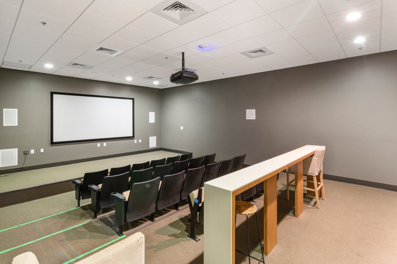 The Art of Drawing Readers In: Your attractive post title goes here Spacious and modern empty cinema room with rows of comfortable chairs and a large screen.
